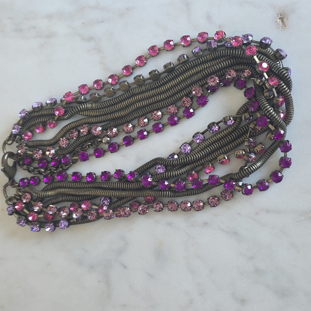 multi-strand necklace featuring pink and purple rhinestones